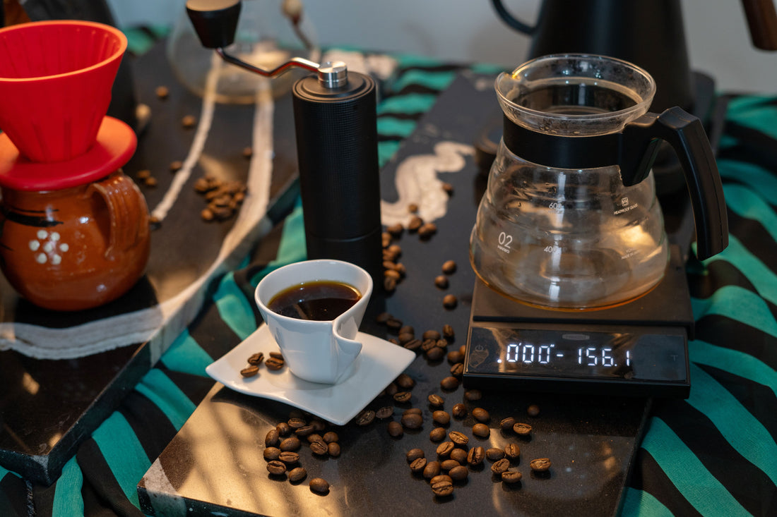 Specialty coffee brewing setup with digital scale, dripper, carafe, and cup for precision extraction measurement