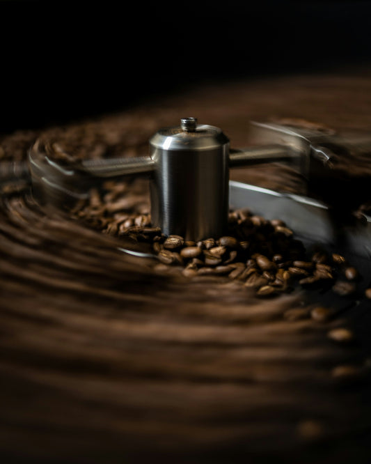 Freshly roasted coffee beans cooling in a metal roasting tray after a batch